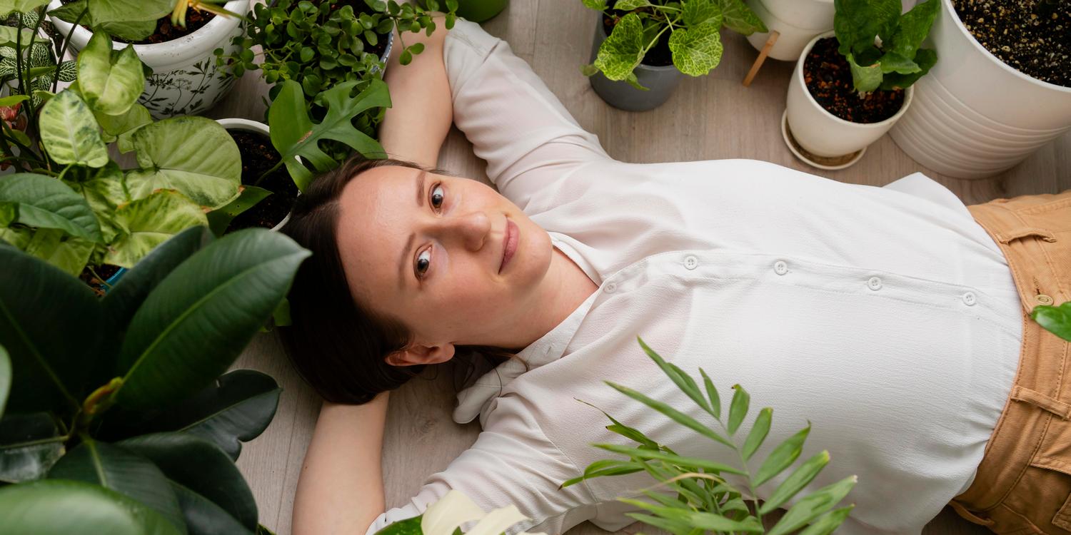 женщина отдыхает среди комнатных растений